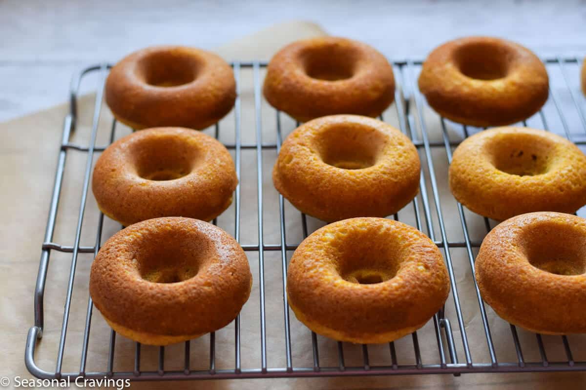 Easy Gluten Free Pumpkin Doughnuts light, flaky pumpkin donuts without frosting on a rack