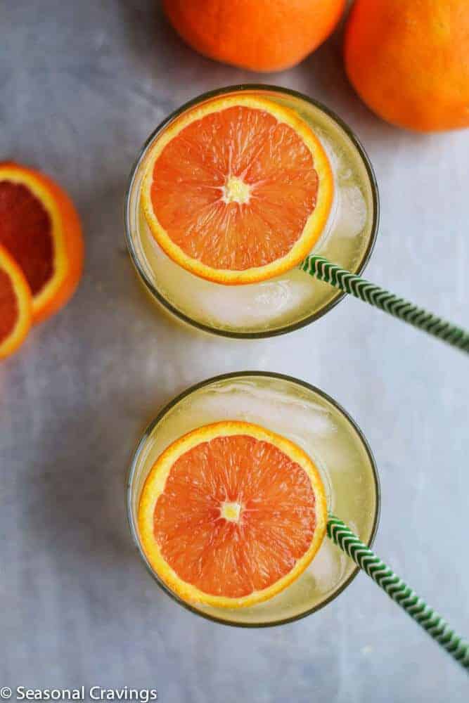 Limoncello and Orange Cocktail in two glasses with green straws