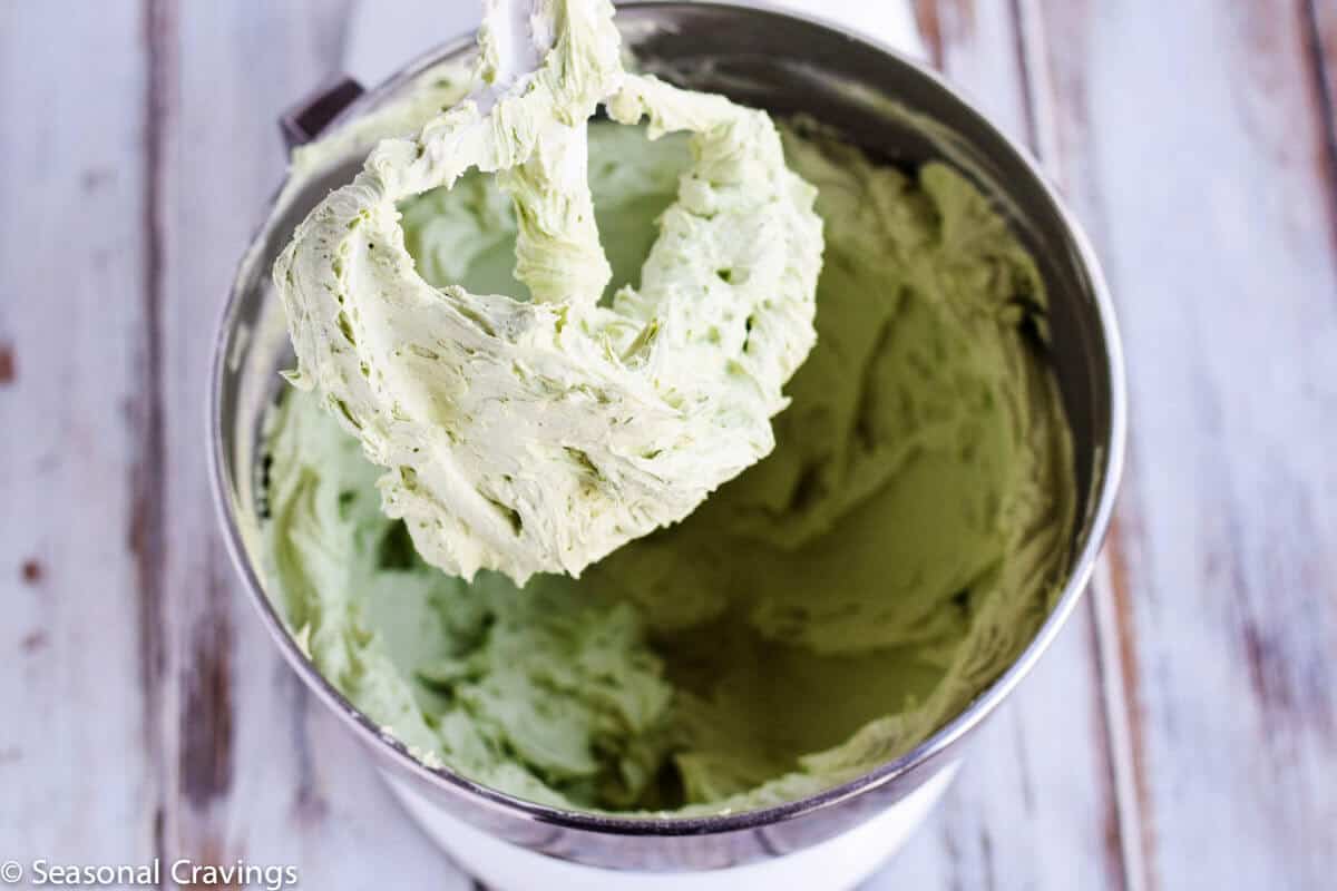 fluffy green buttercream frosting in a bowl