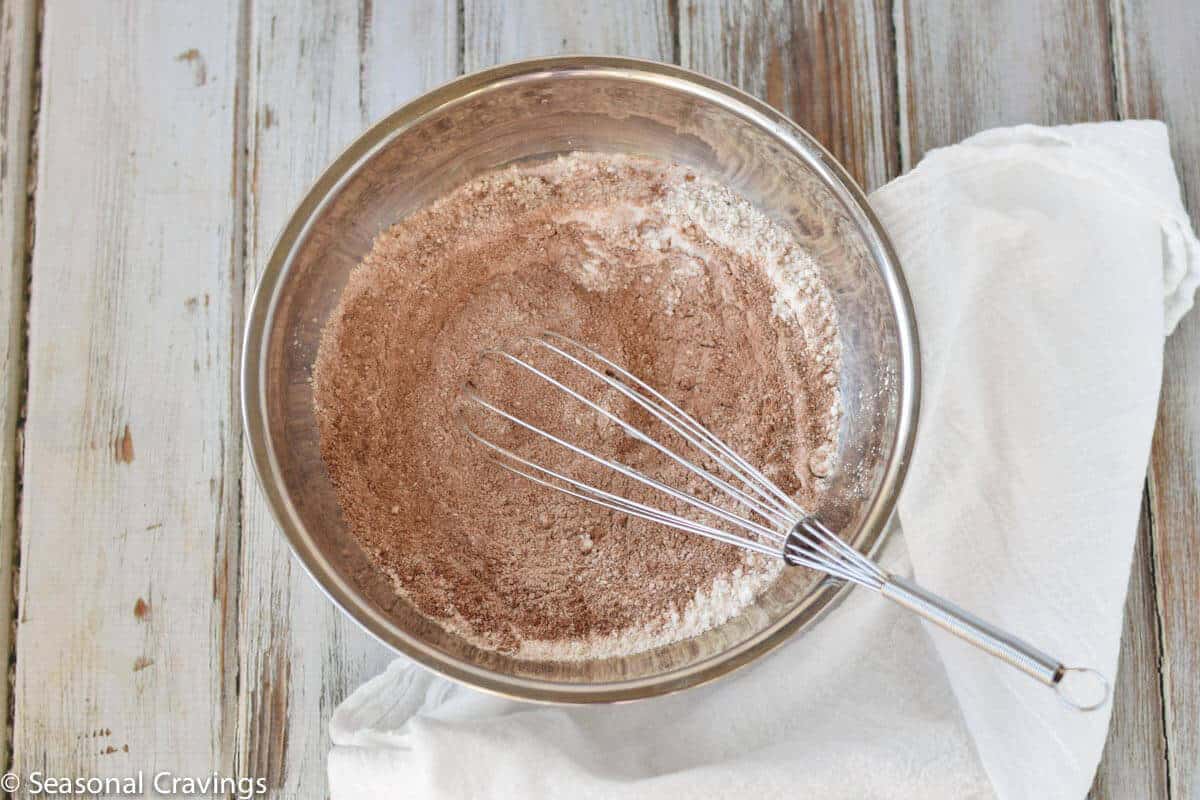 Doughnut mixture in a bowl with whisk