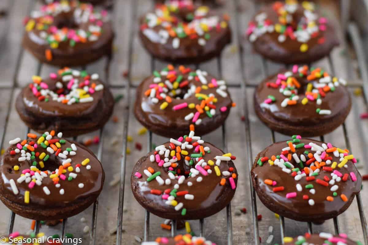 Gluten Free Chocolate cake donuts with sprinkles on a cooling rack