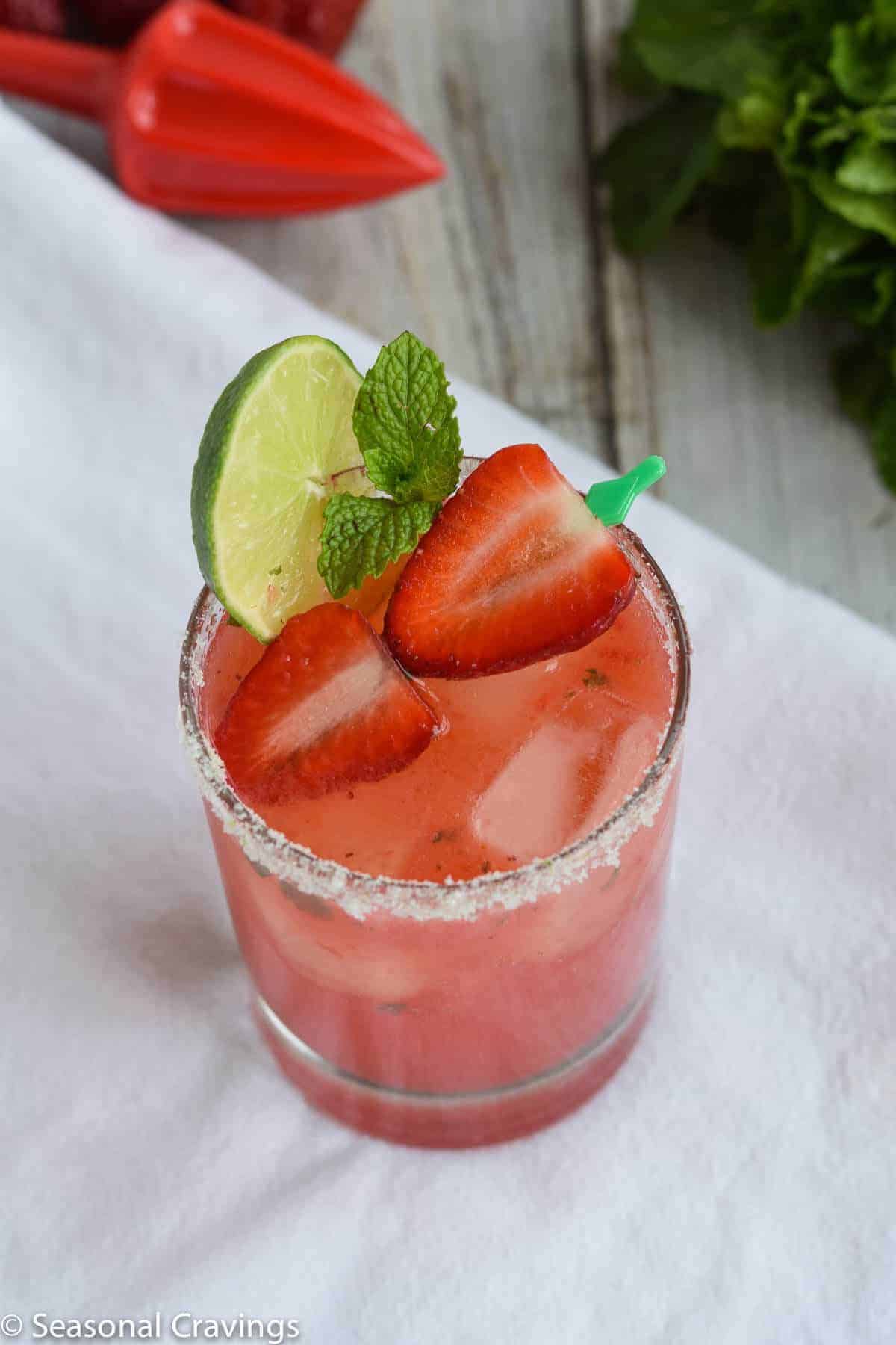 Strawberry Mint Smash in glass with strawberries and mint for garnish