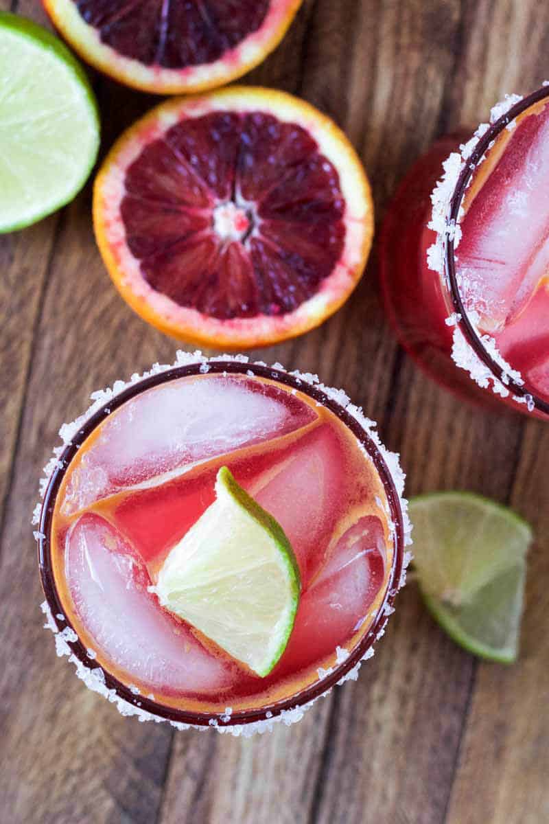 blood-orange-margarita with oranges and limes on the side
