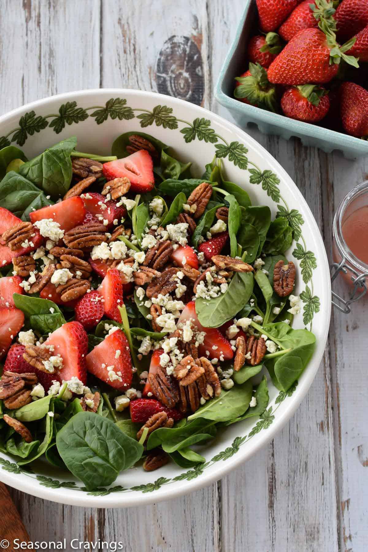 Strawberry and Pecan Spinach Salad in a white bowl