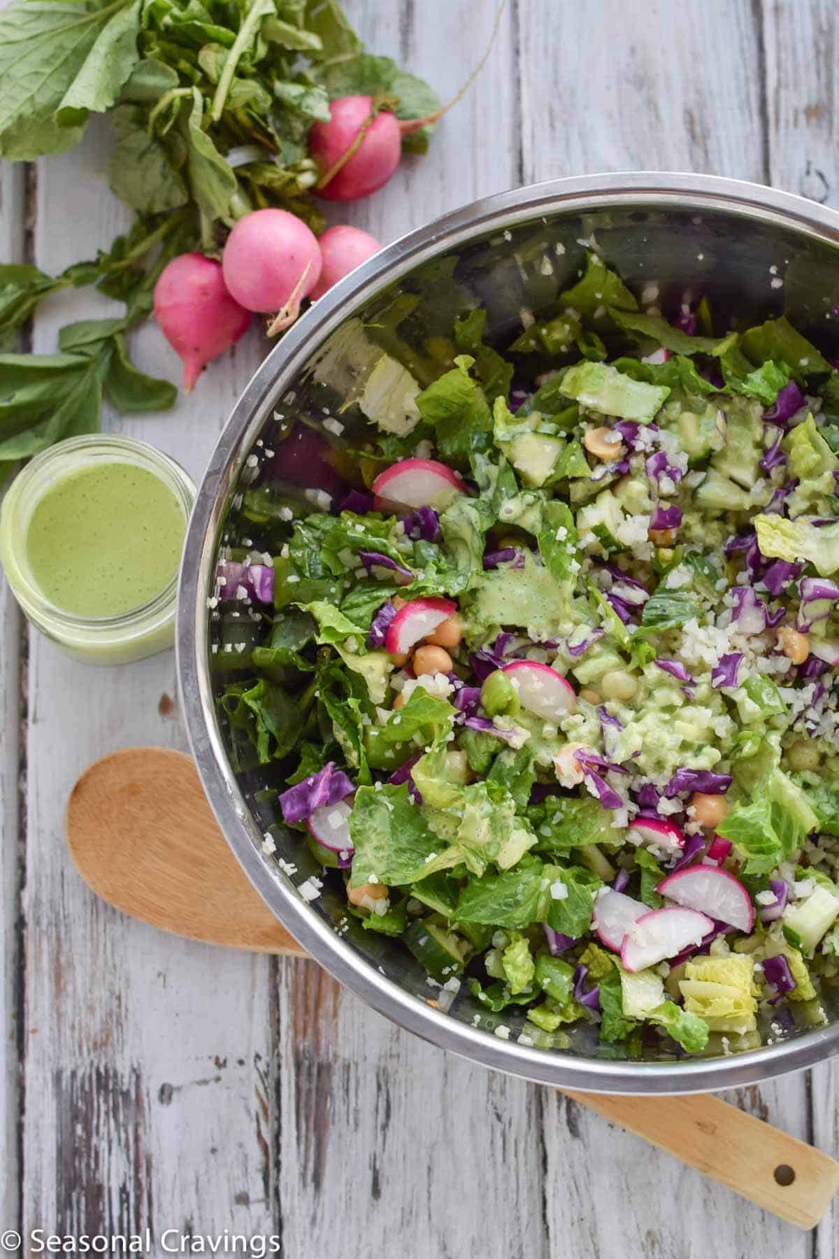 Green Cauliflower Rice Salad in silver bowl with radishes