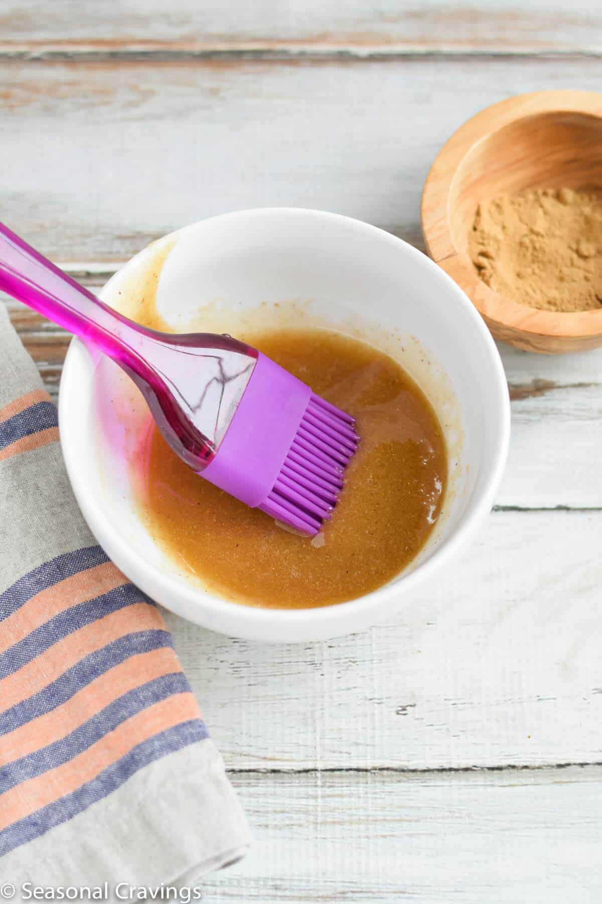 Ginger Honey Glaze in a bowl with a basting brush