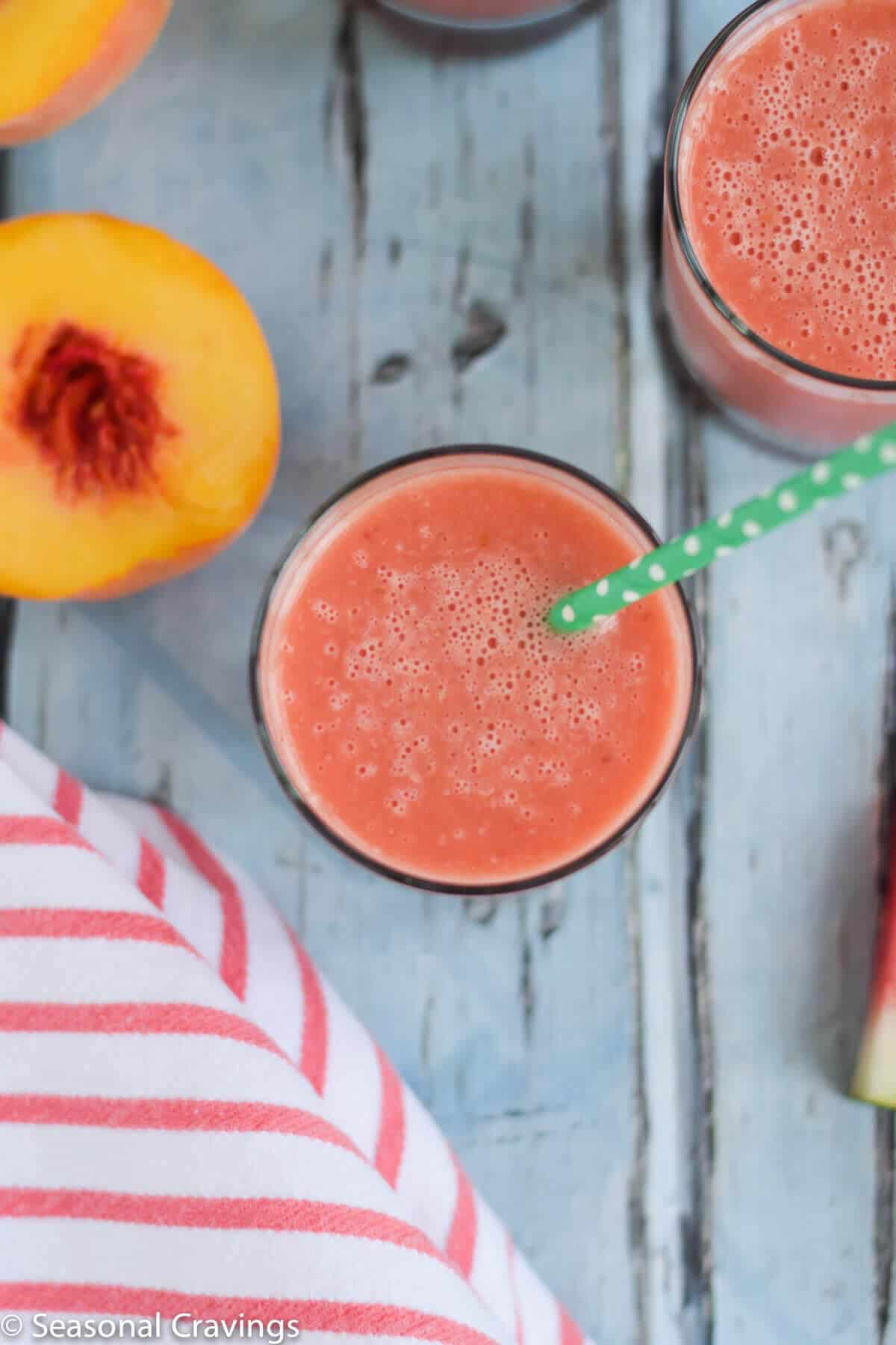 Watermelon Peach Smoothie in a glass with a green straw