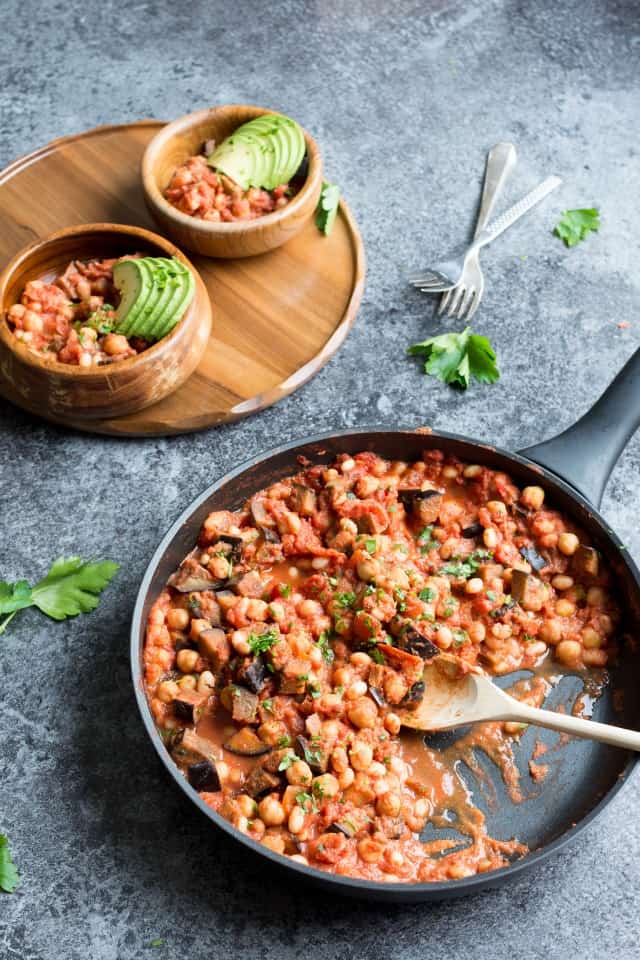 Bean Casserole with avocado and parsley with a wooden spoon