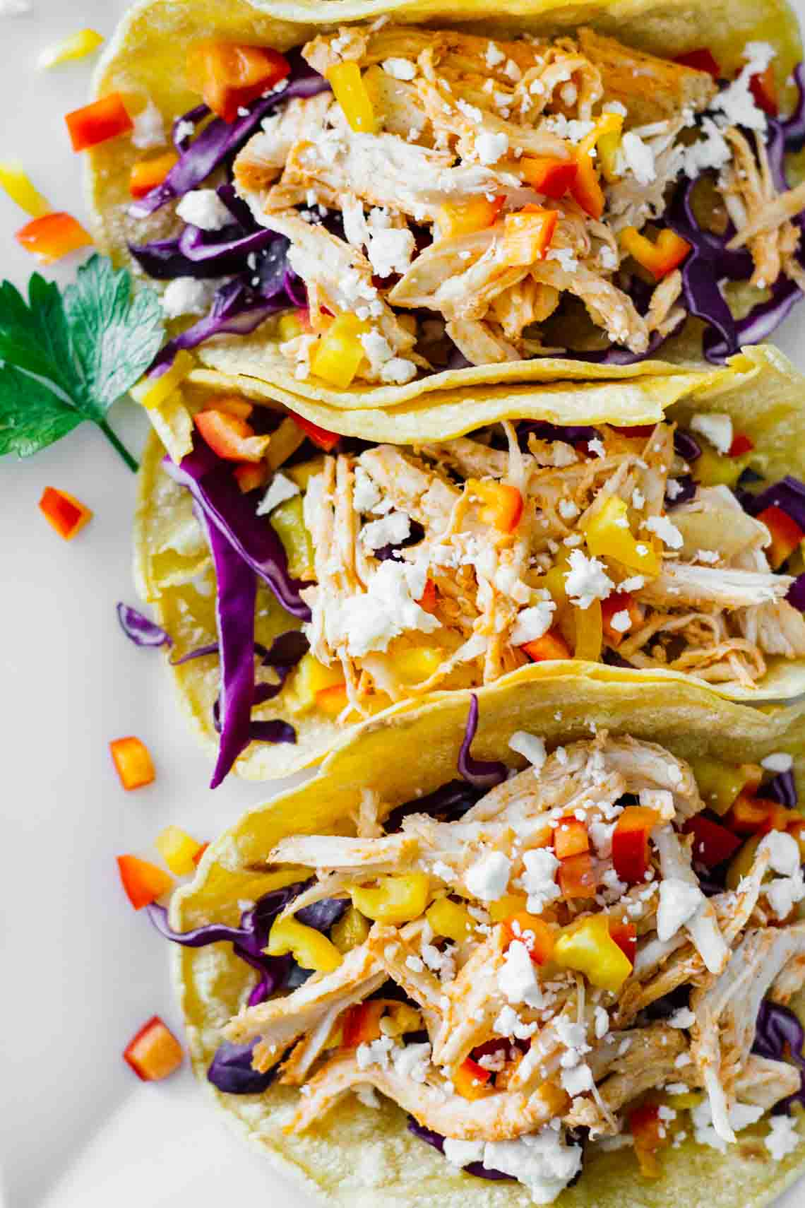 Healthy Sriracha Shredded Chicken Tacos on a white plate