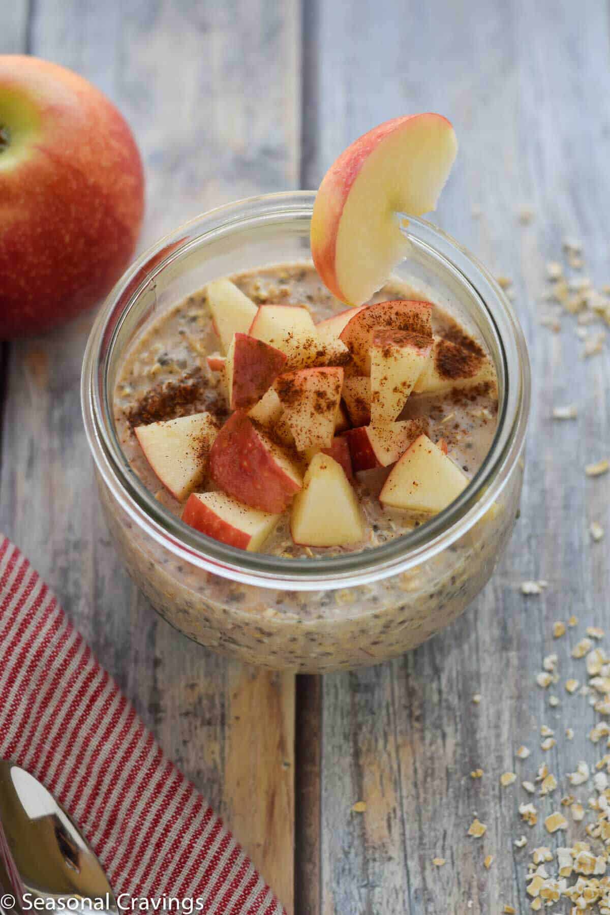 Apple Pie Overnight Oats in a jar with an apple slice on the side