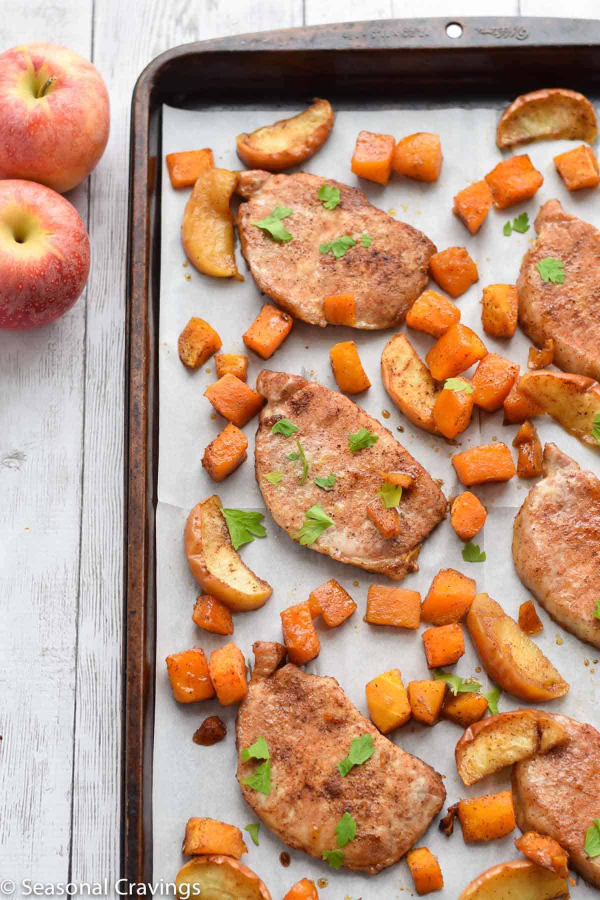 Sheet Pan Brown Sugar Pork Chops on parchment paper on a sheet pan