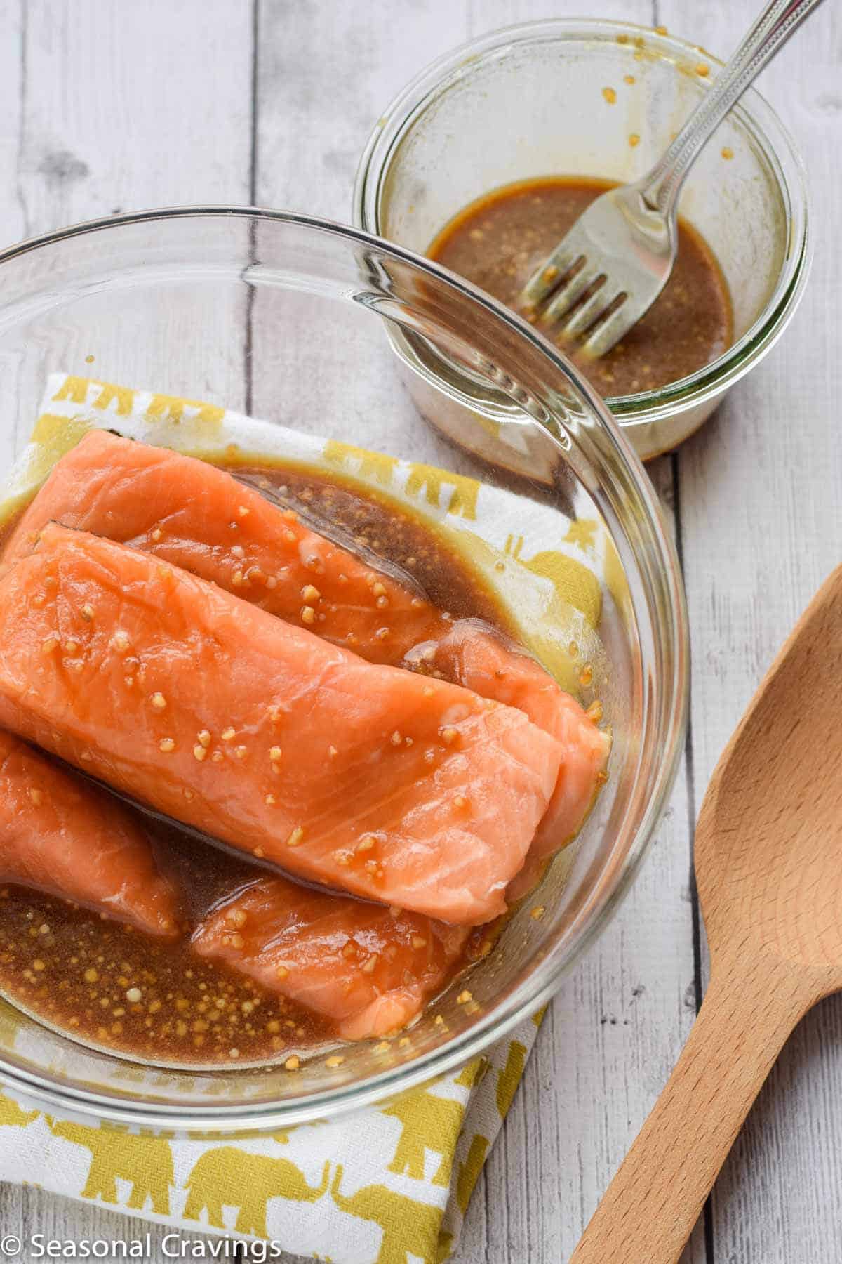 baked teriyaki salmon recipe and marinade in bowl on the side