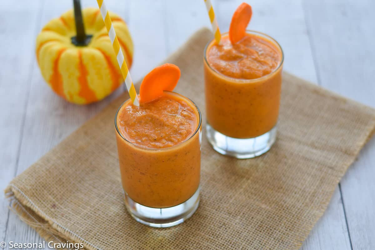 Mango Carrot Chia Smoothie fresh healthy and delicious with a gourd on a white table