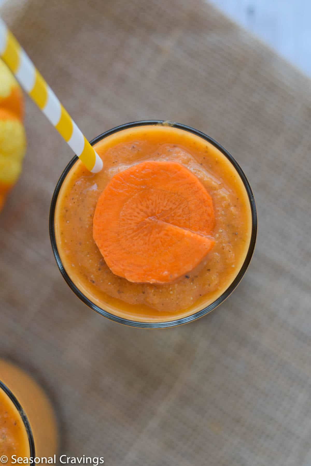 Close up of Mango Carrot Chia Smoothie with round carrot slice on top