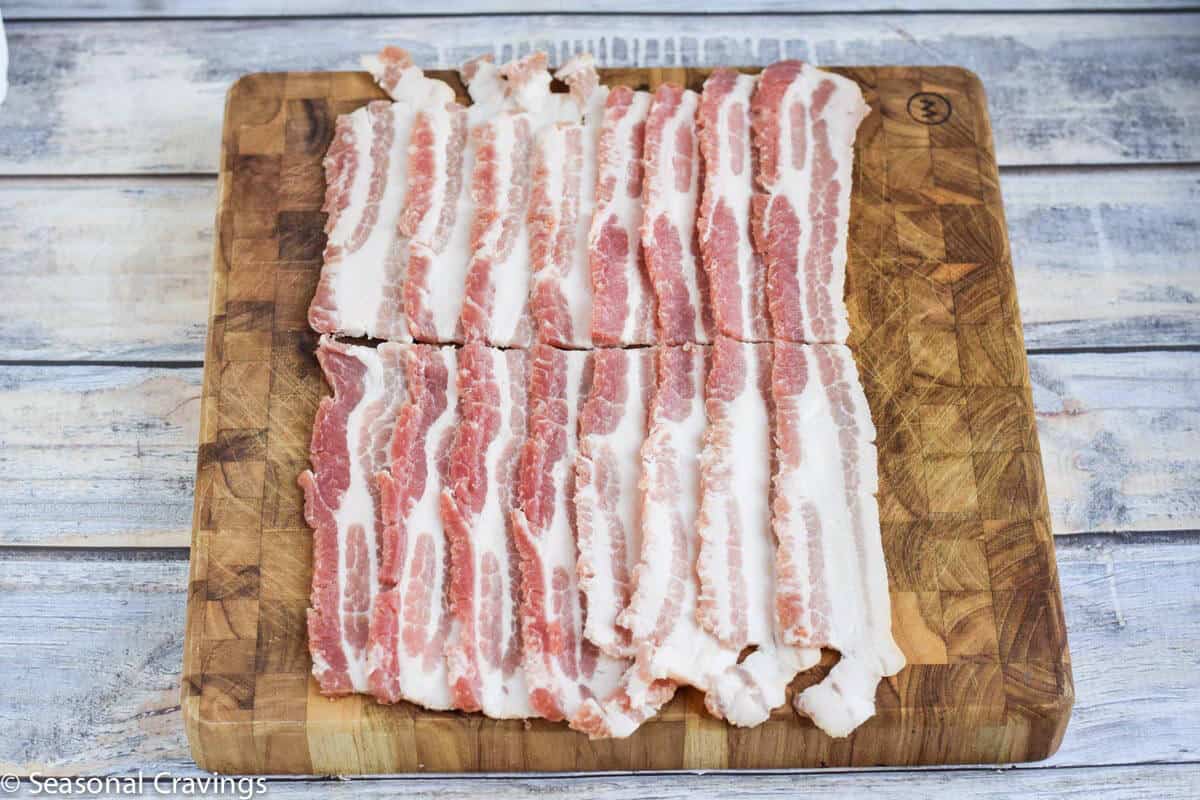 Bacon layed out on cutting board ready for to wrap the pork tenderloin