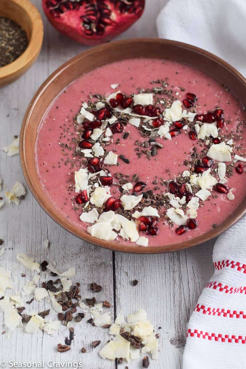smoothie bowl in a bowl with coconut flakes and pomegranate arils