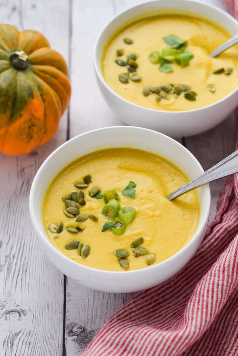 Acorn Squash Soup with Turmeric in two white bowls