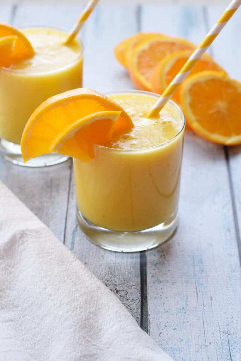 Cold Buster Citrus Smoothie glass with yellow straw and orange slices