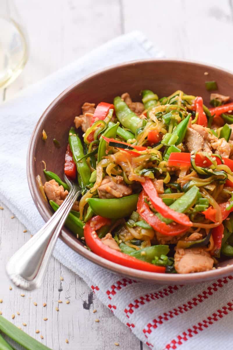 Zucchini Noodle Stir Fry with Chicken close up with a fork