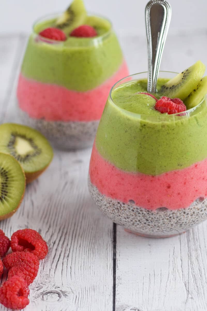 Kiwi and Raspberry Chia Pudding two glasses with spoon