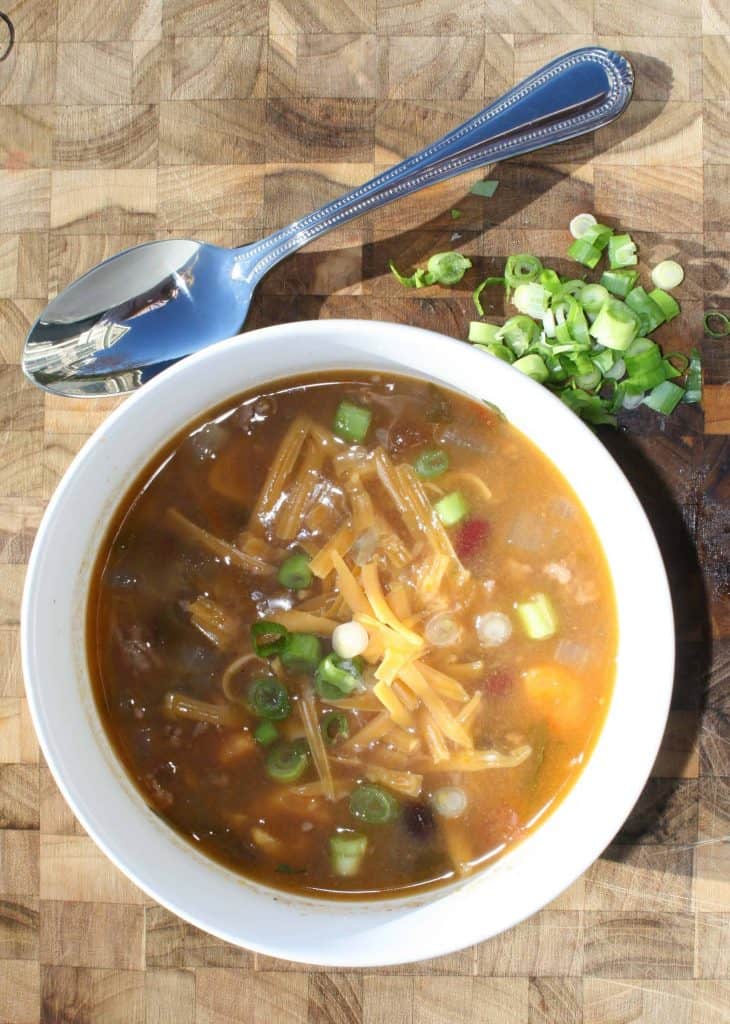 healthy Taco Soup with Sweet Potatoes in a white bowl with green onions