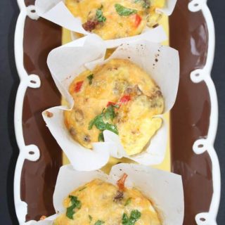 Three mini sausage and egg casseroles are sitting on a plate.