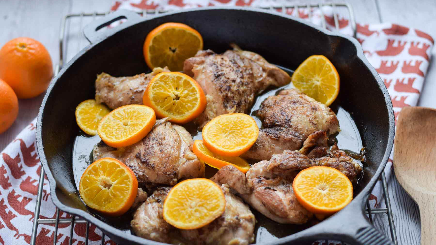 Roasted Clementine Five Spice Chicken in a cast iron skillet.