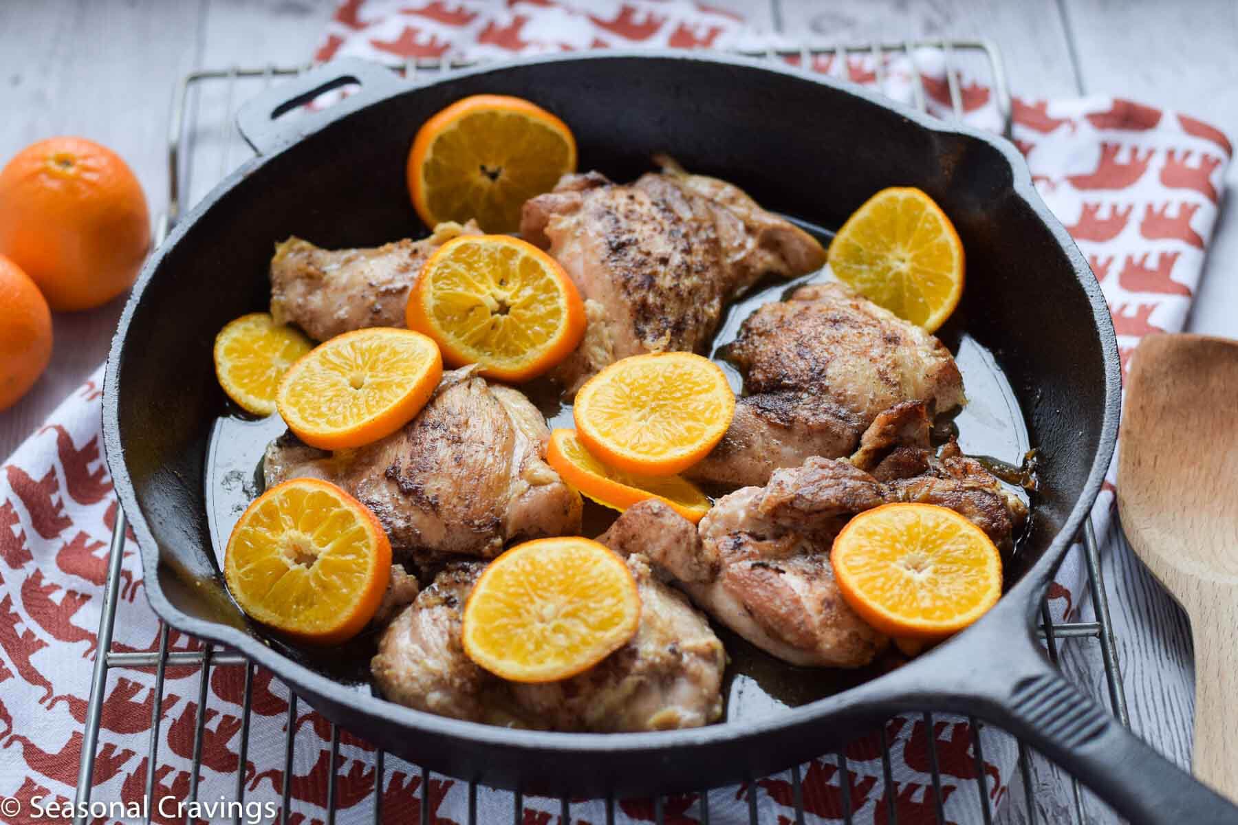 Roasted Clementine Five Spice Chicken in a cast iron skillet.