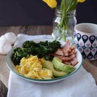 A Kale and Egg Power Bowl, complete with eggs, ham, kale and a cup of coffee.