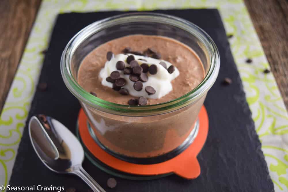 Overnight Chocolate Oatmeal Protein Bowl with chocolate chips and a spoon