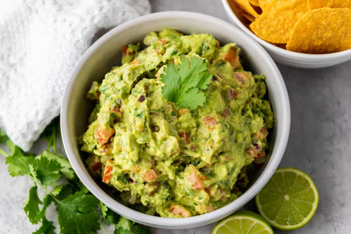 bowl of guacamole with limes