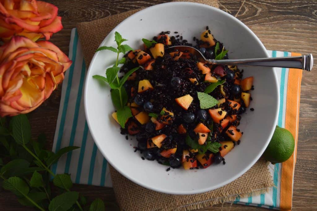 Black Rice With Peaches and Blueberries with spoon