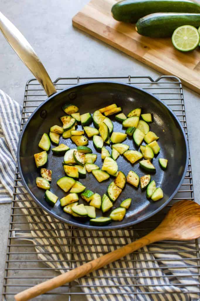 sauteed zucchini in a pan on a cooling rack