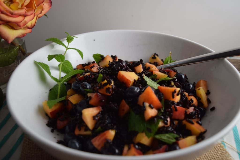 Black Rice With Peaches and Blueberries in bowl