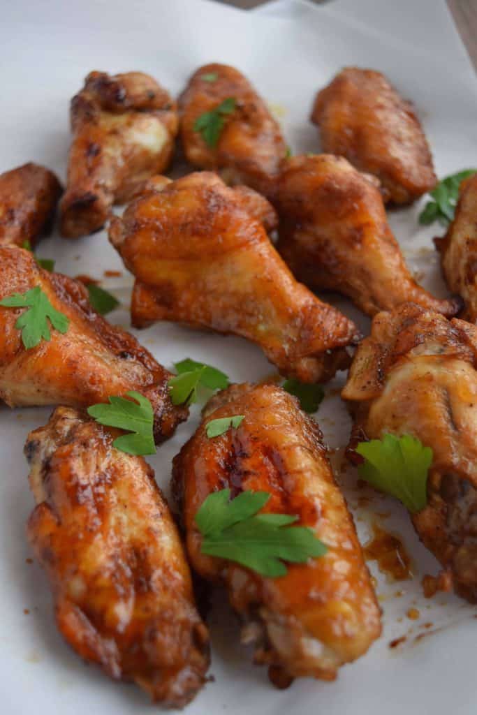 Easy Five Spice Chicken Wings on parchment paper with parsley