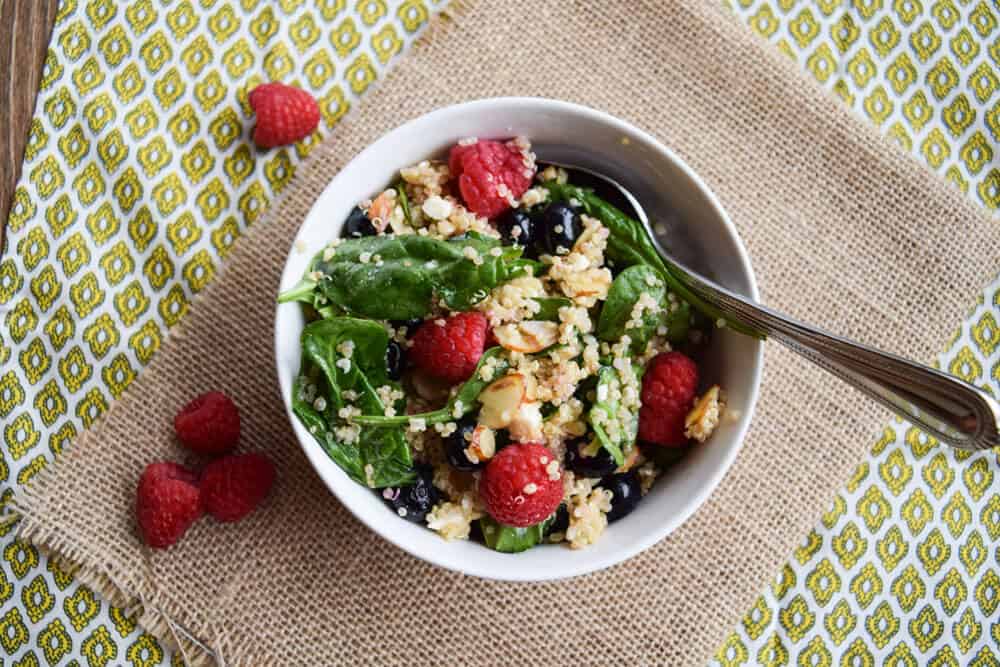 Spinach berry power salad with berries with a spoon