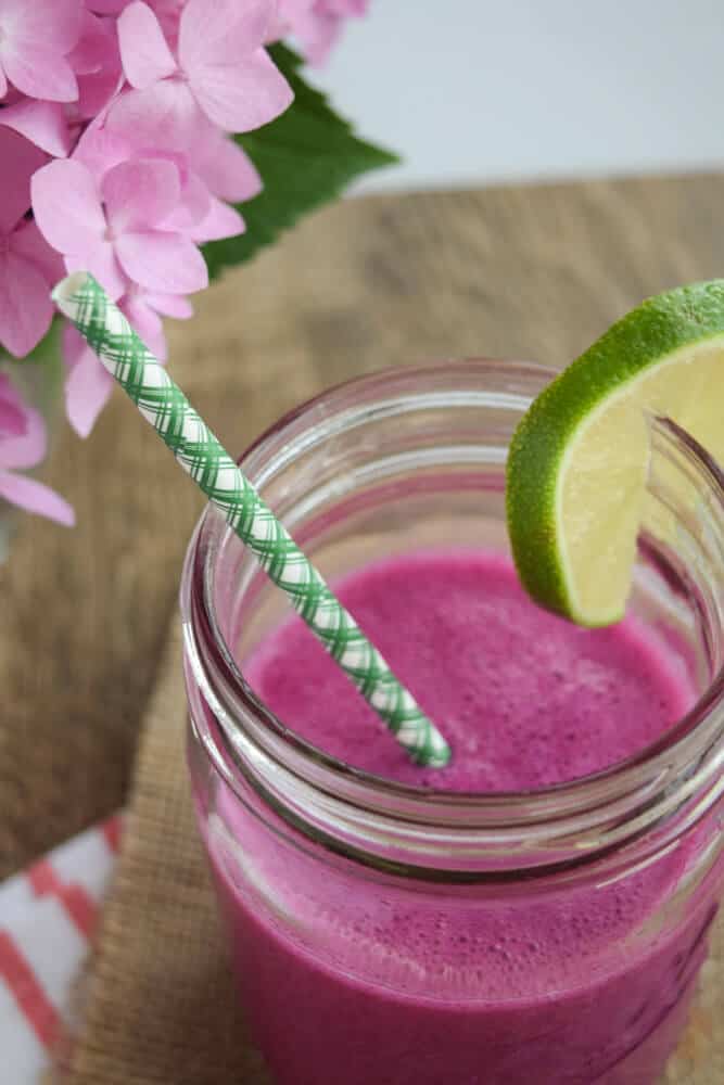 Dragonfruit Smoothie with a lime and straw