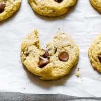 Close up of chocolate chip cookie on parchment paper