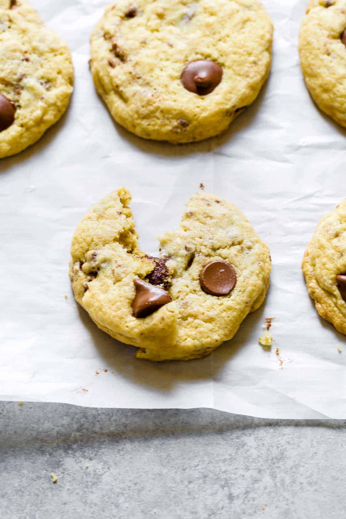 Close up of chocolate chip cookie on parchment paper