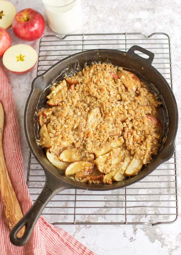 gluten free apple crisp with oats in a cast iron skillet