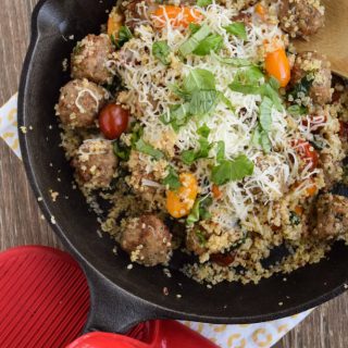 Cheesy Quinoa With Meatballs cooked in a skillet.
