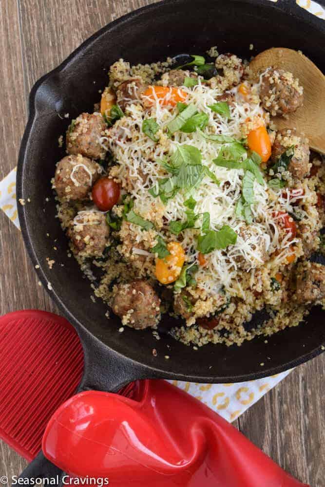 Cheesy Quinoa With Meatballs in a cast iron skillet