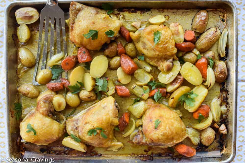Sheet Pan Chicken With Tumeric with a spatula