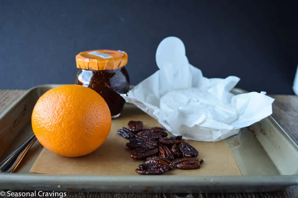 Baked Brie recipe ingredients on a sheet pan