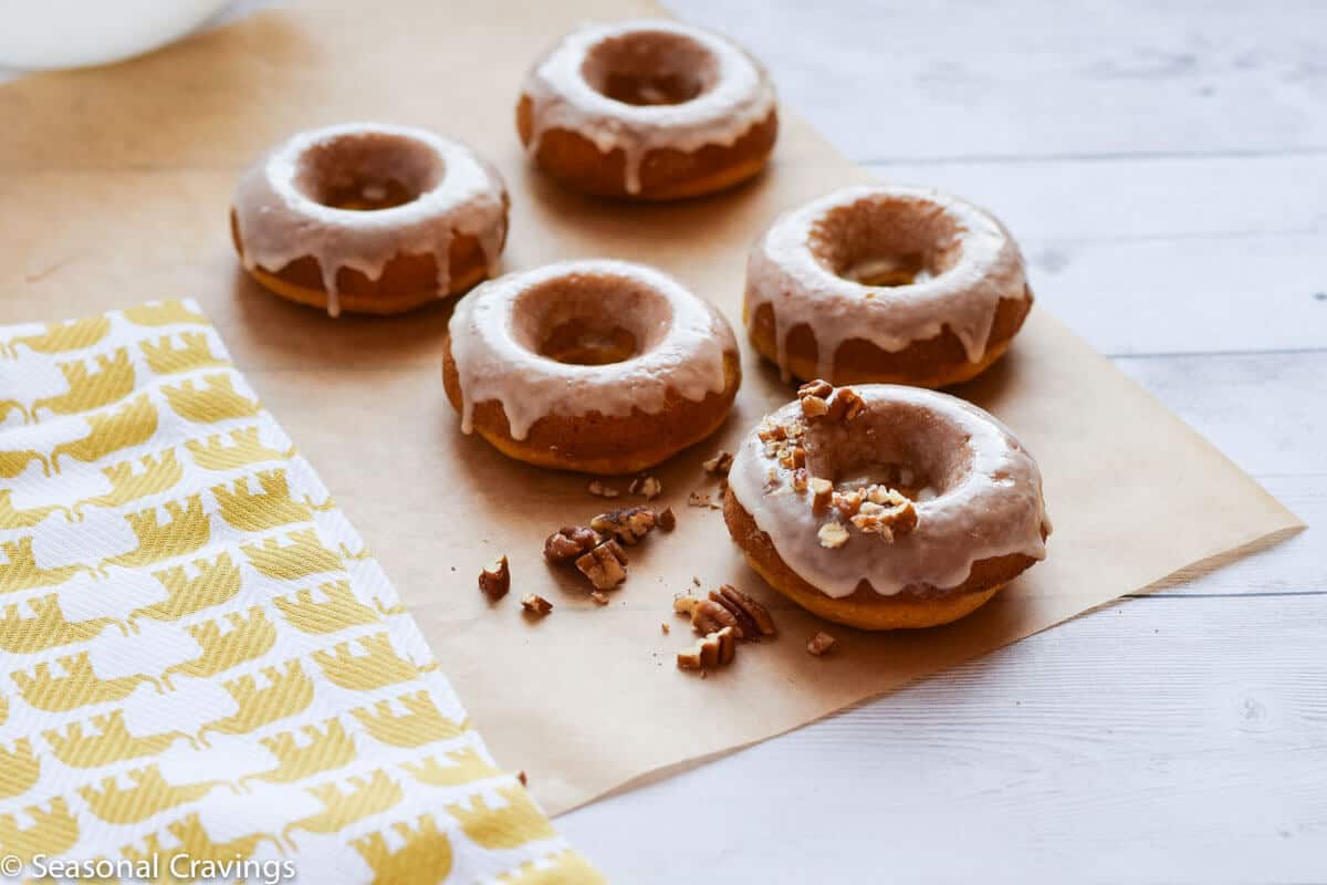 Easy Gluten Free Pumpkin Doughnuts light flaky and sweet donuts on parchment paper