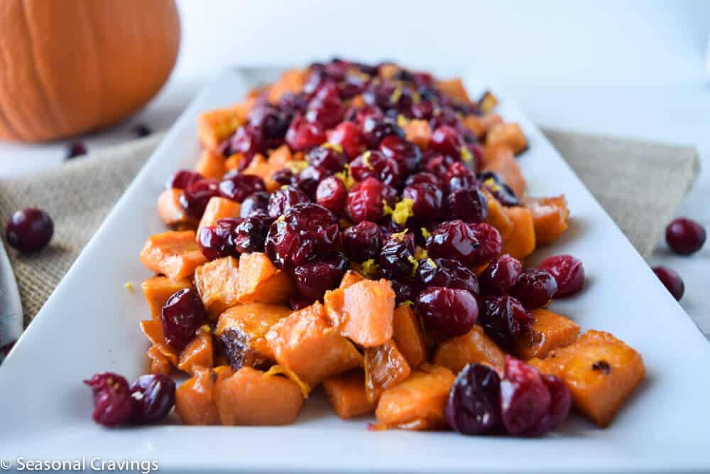 Roasted Maple Sweet Potatoes with Cranberries on a white plate