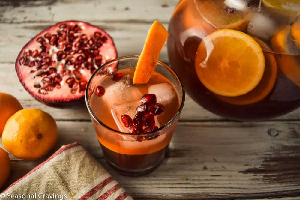 Pomegranate Orange Sangria in a glass with orange on the side