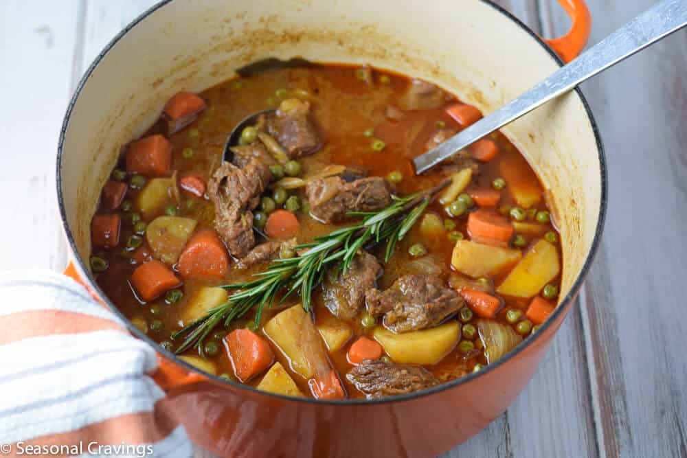 Apple Cider Beef Stew in an orange pot.