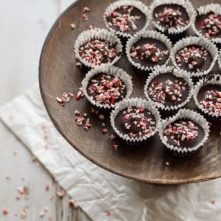 Creamy Chocolate Peppermint Cups arranged on a wooden plate.