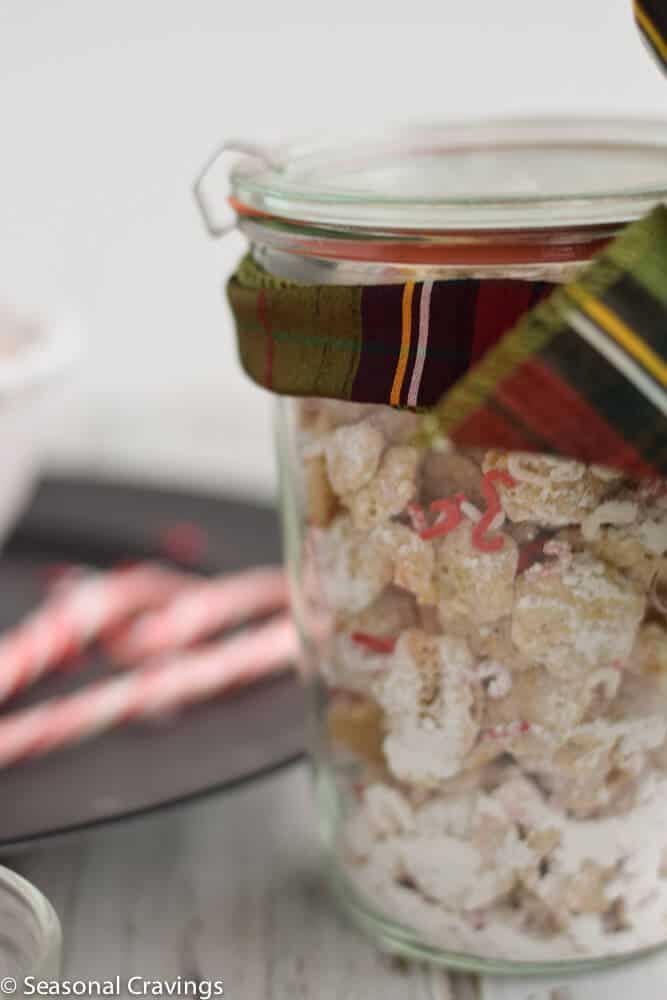 Peppermint Christmas Puppy Chow in a weck jar with ribbon on top